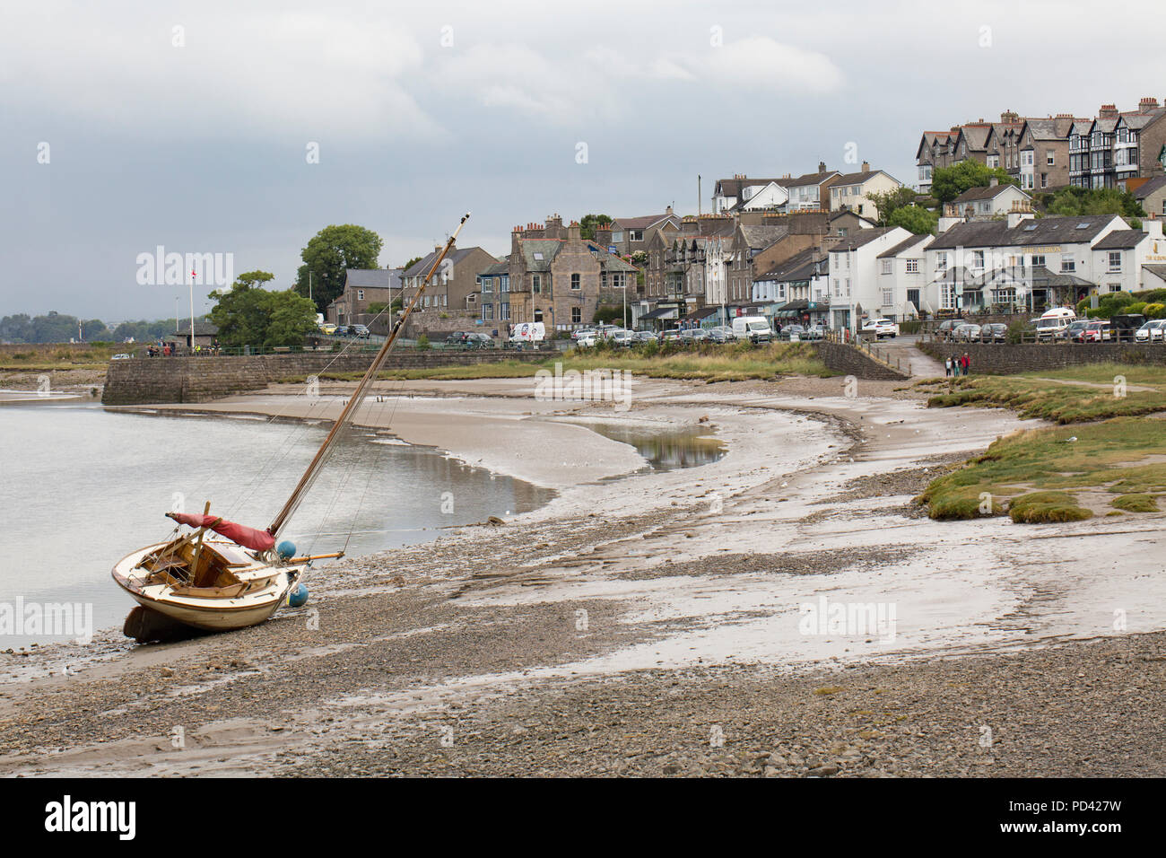 A yacht at low tide on the edge of the Kent estuary next to the village of Arnside in Cumbria North West England UK GB Stock Photo