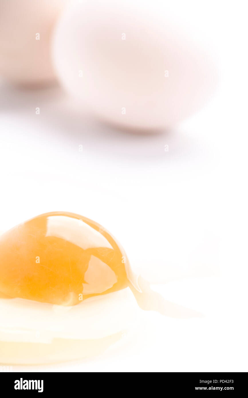 whole and broken white chicken eggs closeup on white Stock Photo - Alamy