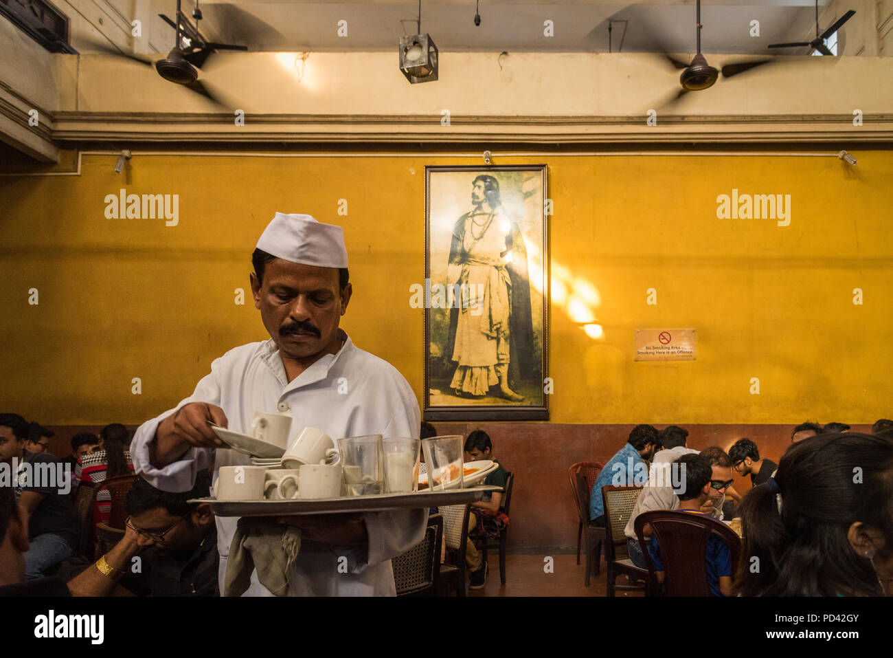 Man bussing tables in the historic Indian Coffee House, College Street, Kolkata, India Stock Photo
