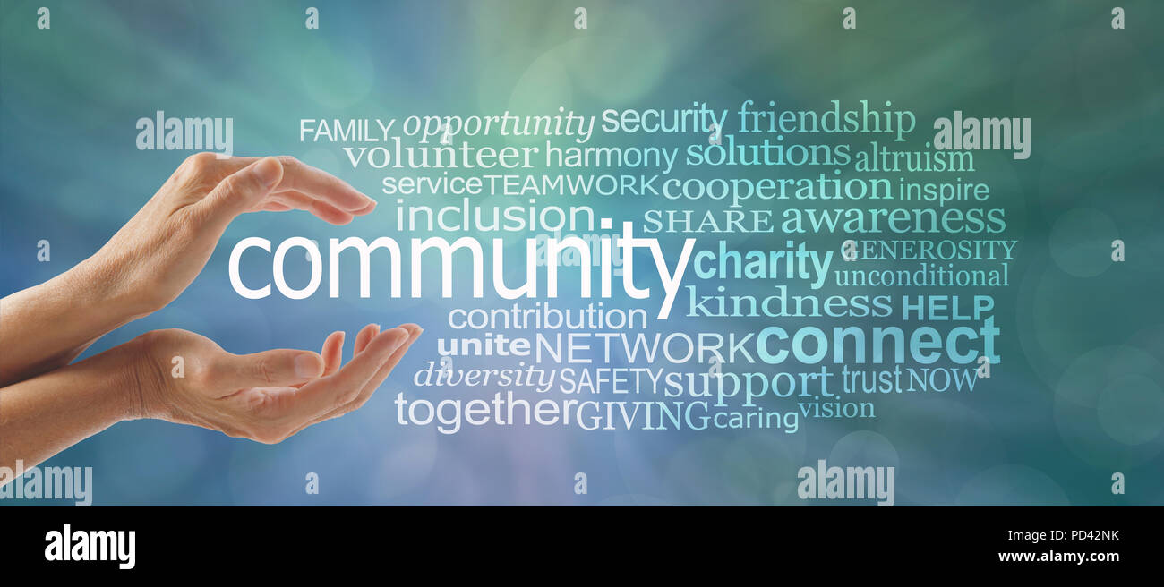 Female cupped hands around the word COMMUNITY and a relevant word tag cloud against a blue green bokeh background - make a difference Stock Photo