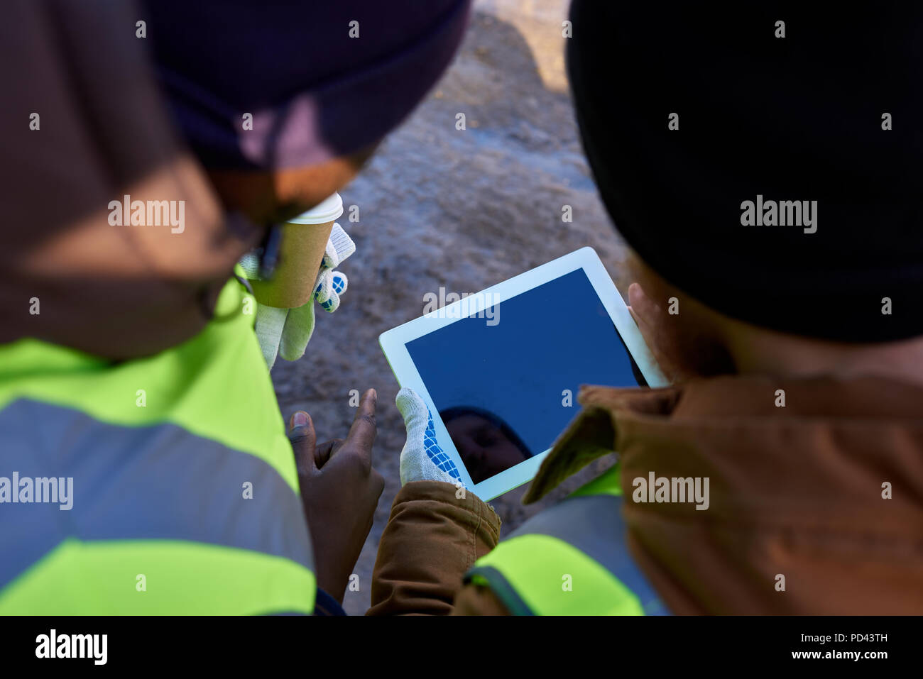 Miners Using Tablet Outdoors Stock Photo