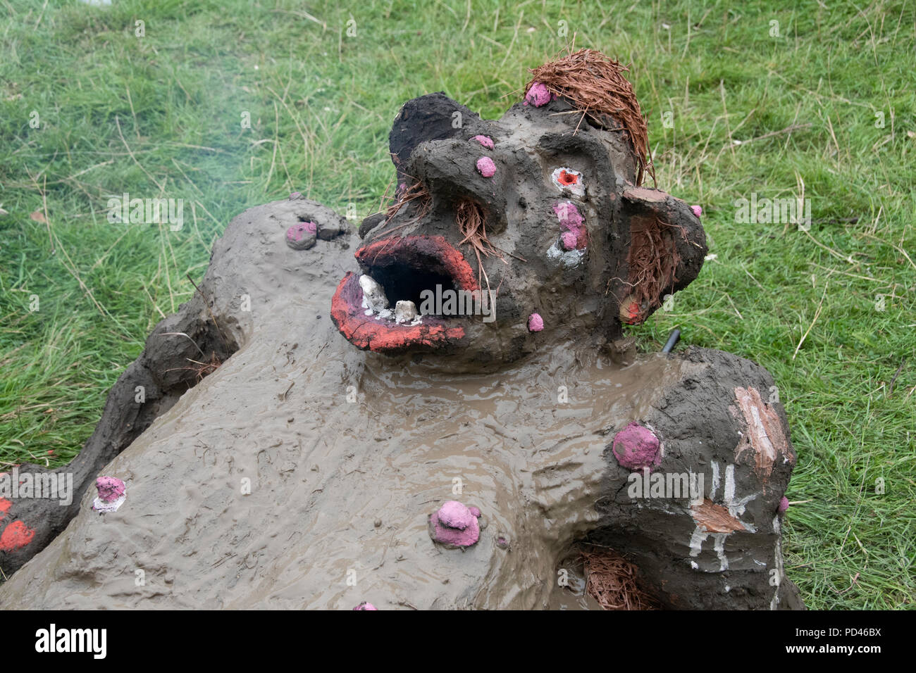 Chepstow, Wales – Aug 14: Make-up decorates the face of a newly made troll faced wood fired earth oven on 14 Aug 2015 at The Green Gathering Stock Photo