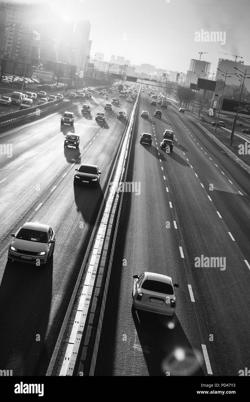 Cars on highway. Sunset cityscape. Contrejour wallpaper Stock Photo