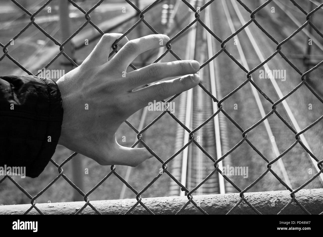 Hand is in jail dramatic negative shot Stock Photo