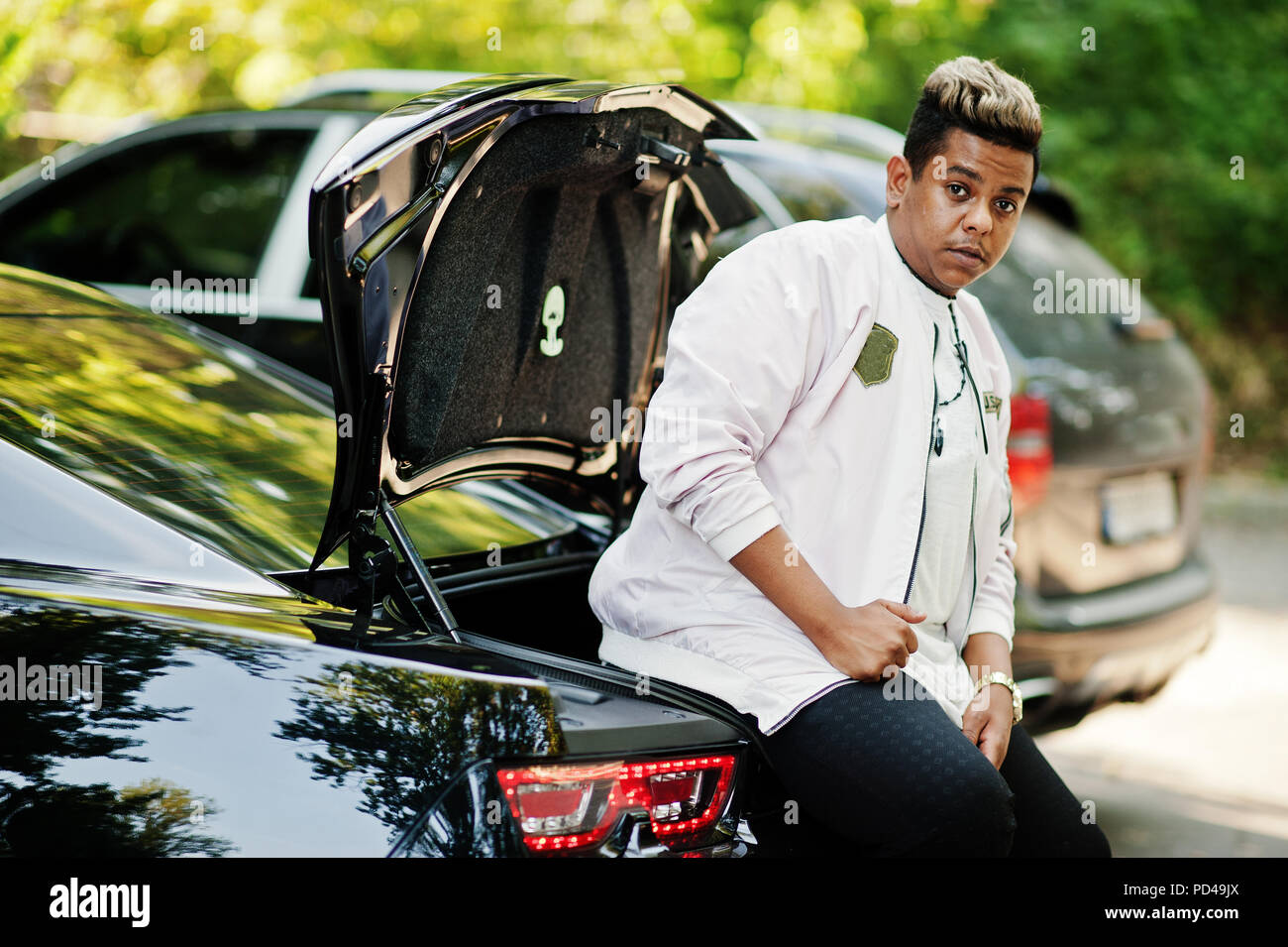 Free Photo | African american woman posed against white car in forest road