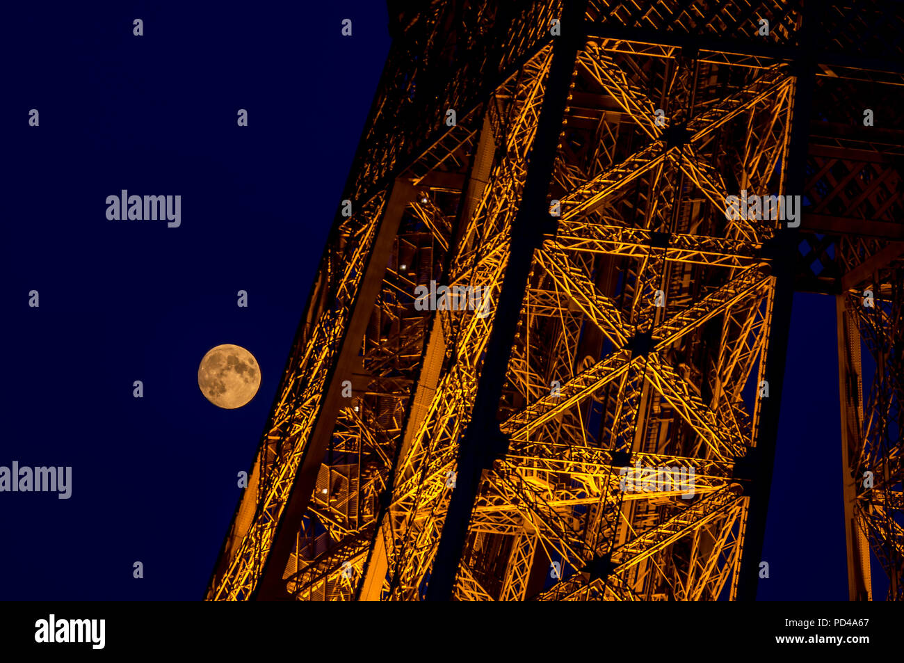 Close-up on Eiffel tower with the full moon in background- Paris, France Stock Photo