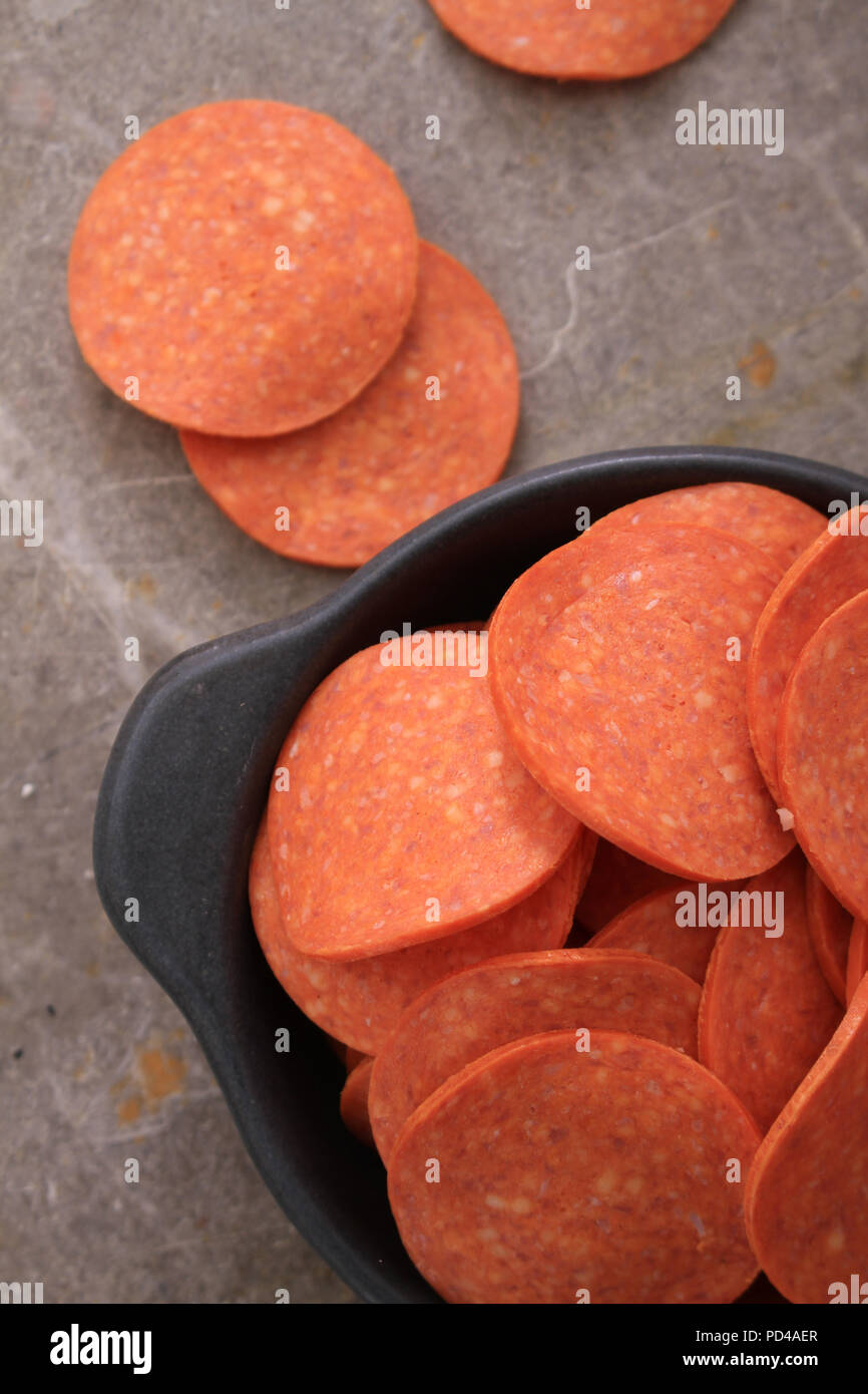 pepperoni slices in dish Stock Photo Alamy