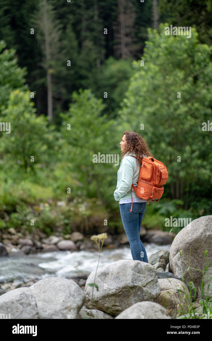 Tourist woman are hiking at the waterfall in Nature. Stock Photo