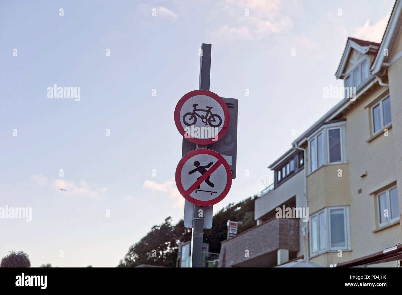 No skateboarding and no cycling - confusing road signs Stock Photo
