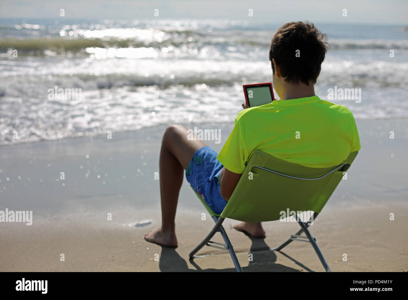 Teenager boy sitting on chair hi-res stock photography and images - Alamy