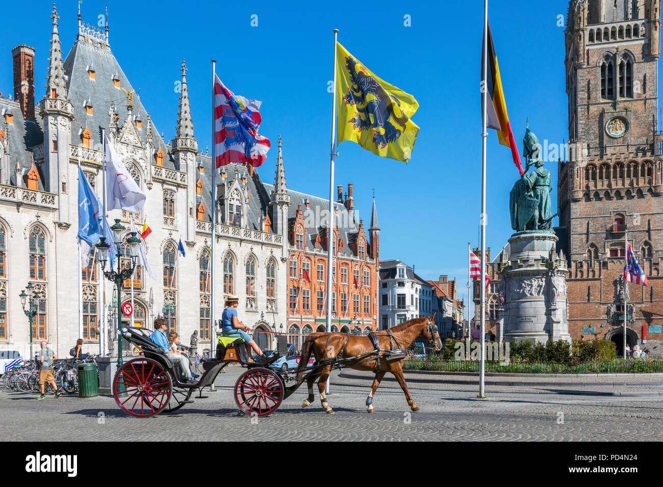 Horse and trap taking tourists for a city tour, Markt Square, Bruges, Belgium Stock Photo