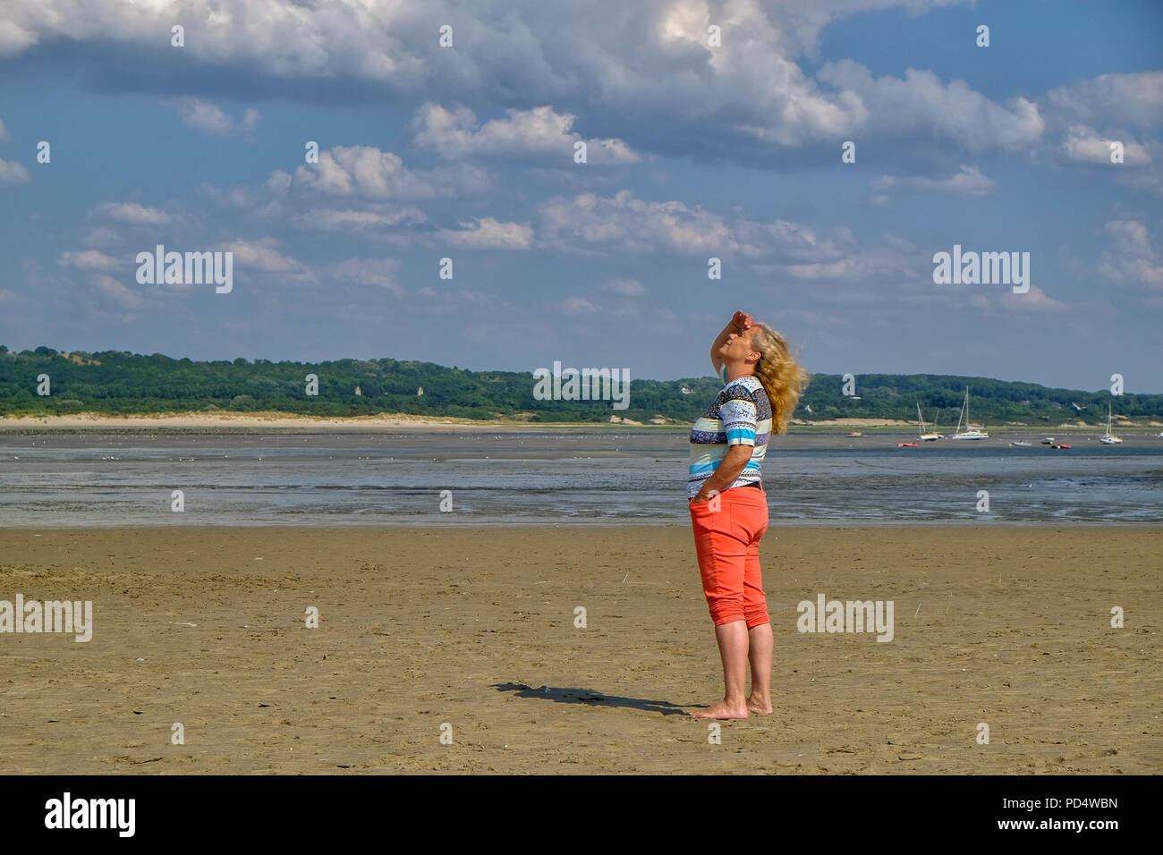 Old Woman standing at the beach at Le Touquet Paris-Plage in France Stock Photo