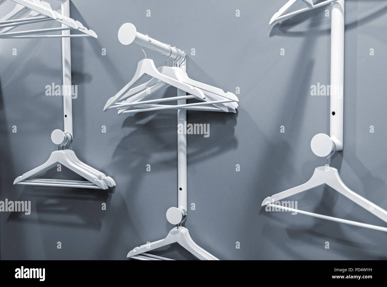 Empty hangers hanging on a clothes rack in the office dressing room, abstract looking indoors interior picture Stock Photo
