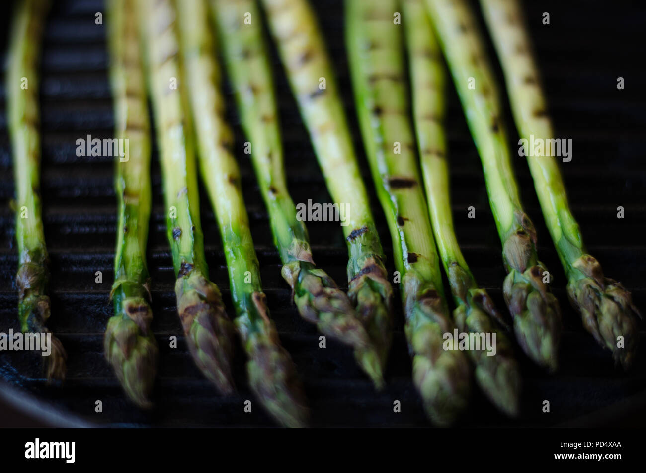 Grilled green asparagus on a cast iron grillpan Stock Photo