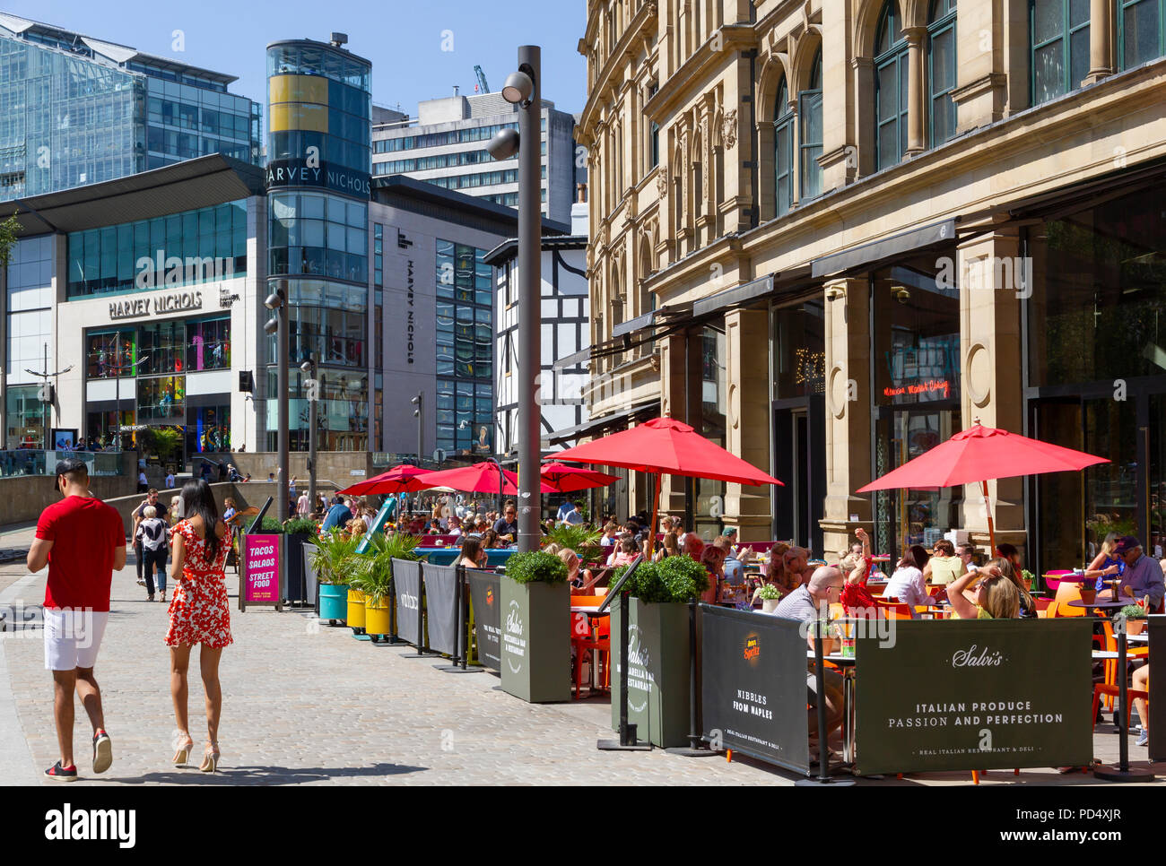 People dining outside the Corn Exchange, in Exchange Square Manchester. Stock Photo