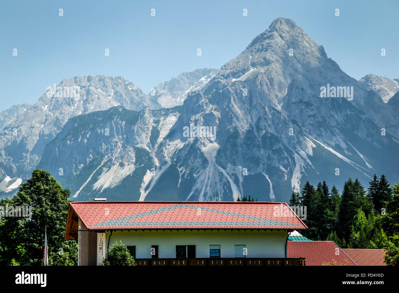 View of the Zugspitze mountains in Austrian alps in summer with holiday villages and tourist destinations Stock Photo