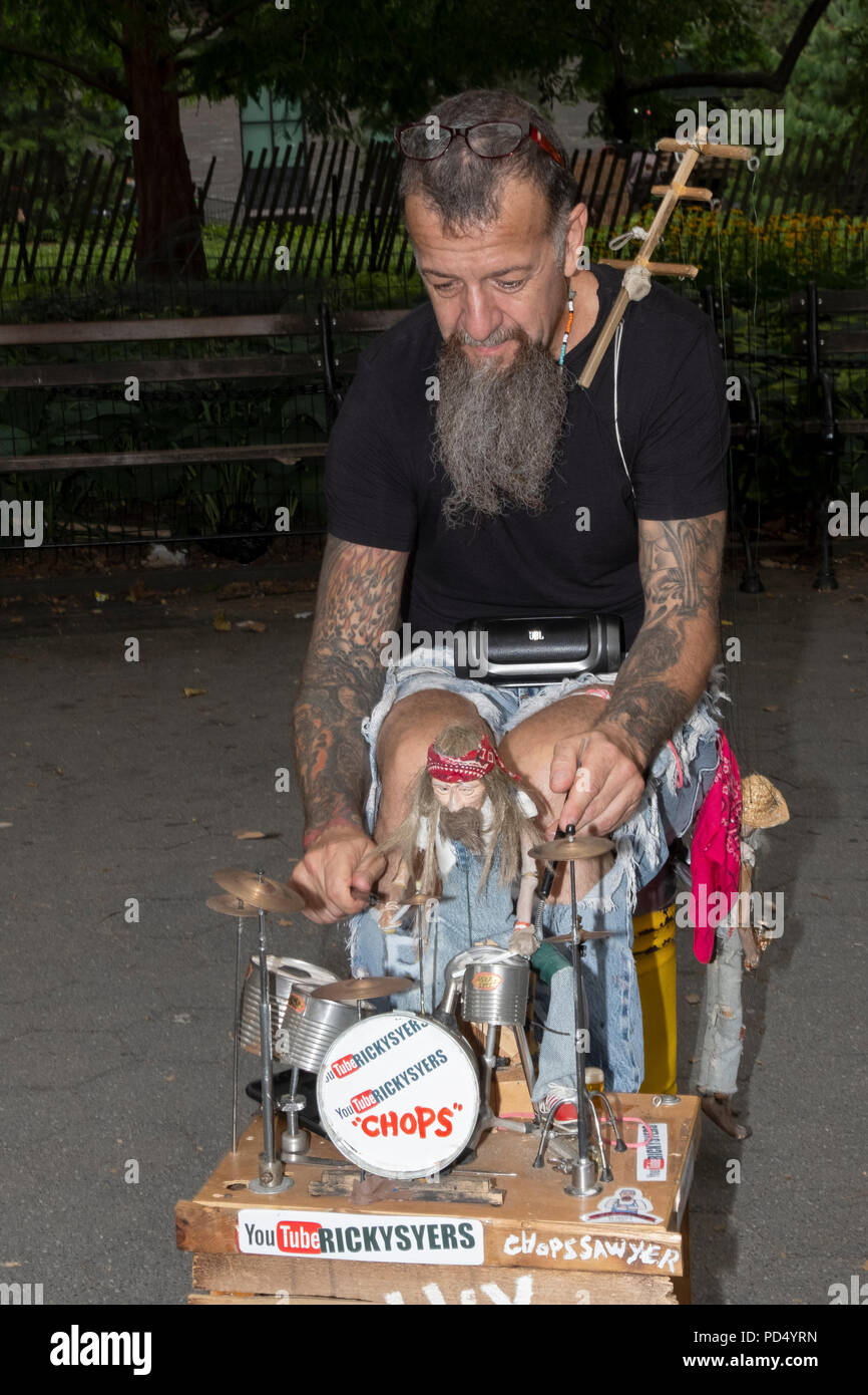 Marionettist Ricky Syers and his marionette Chops Sawyer the drummer performing in Washington Square Park in Greenwich Village, New York City. Stock Photo