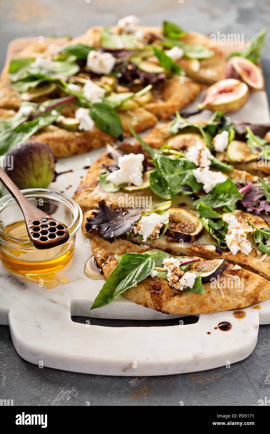 Fall flatbread pizza with fresh figs, arugula and goat cheese Stock