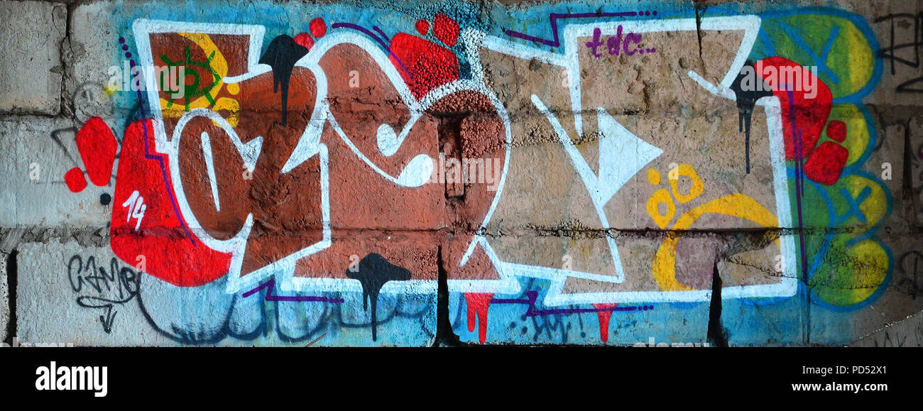 Detailed image of very old and aged color graffiti drawing on the wall. Background grunge street art picture Stock Photo