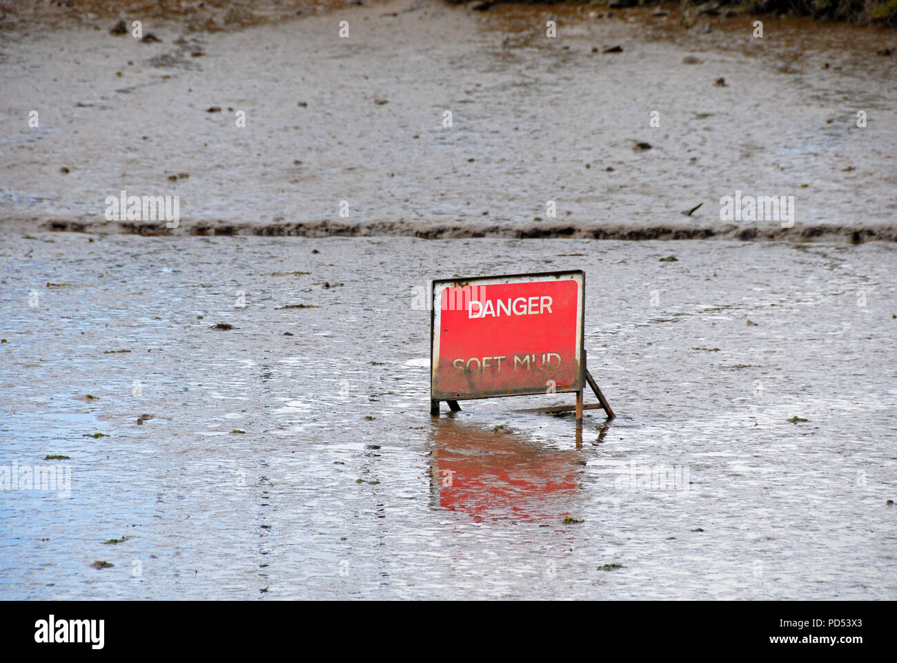 Sign, Soft Mud, partially submerged in mud Stock Photo