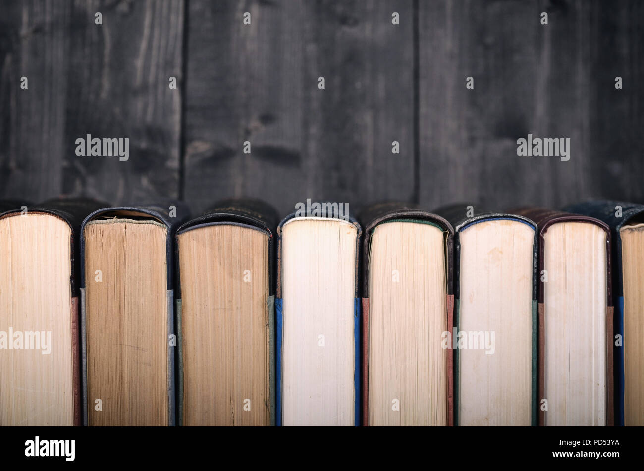 Old Law books on the black wooden background, black wooden backdrop. Stock Photo