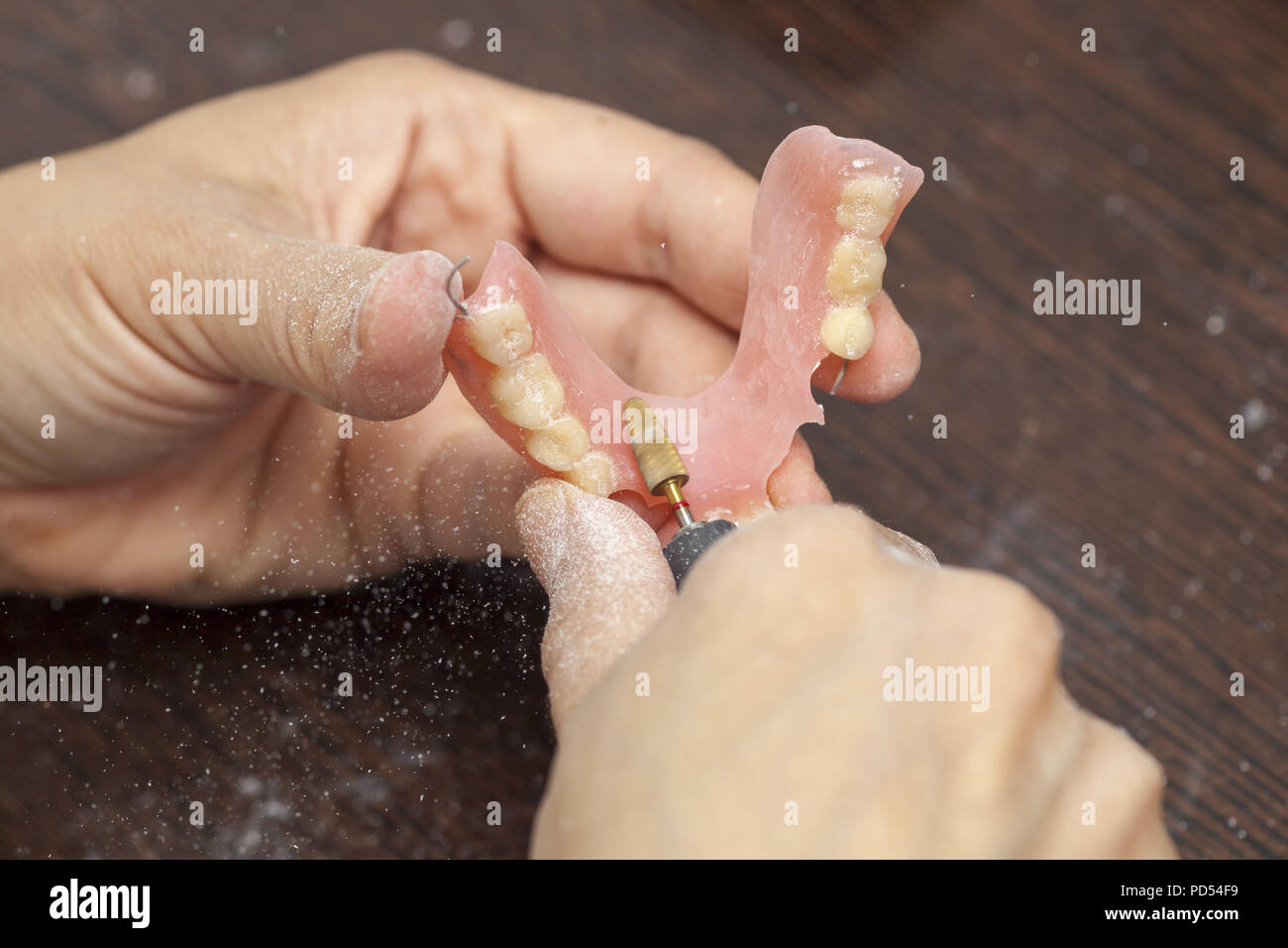 Dental technician make denture prosthetic in dental laboratory, hands