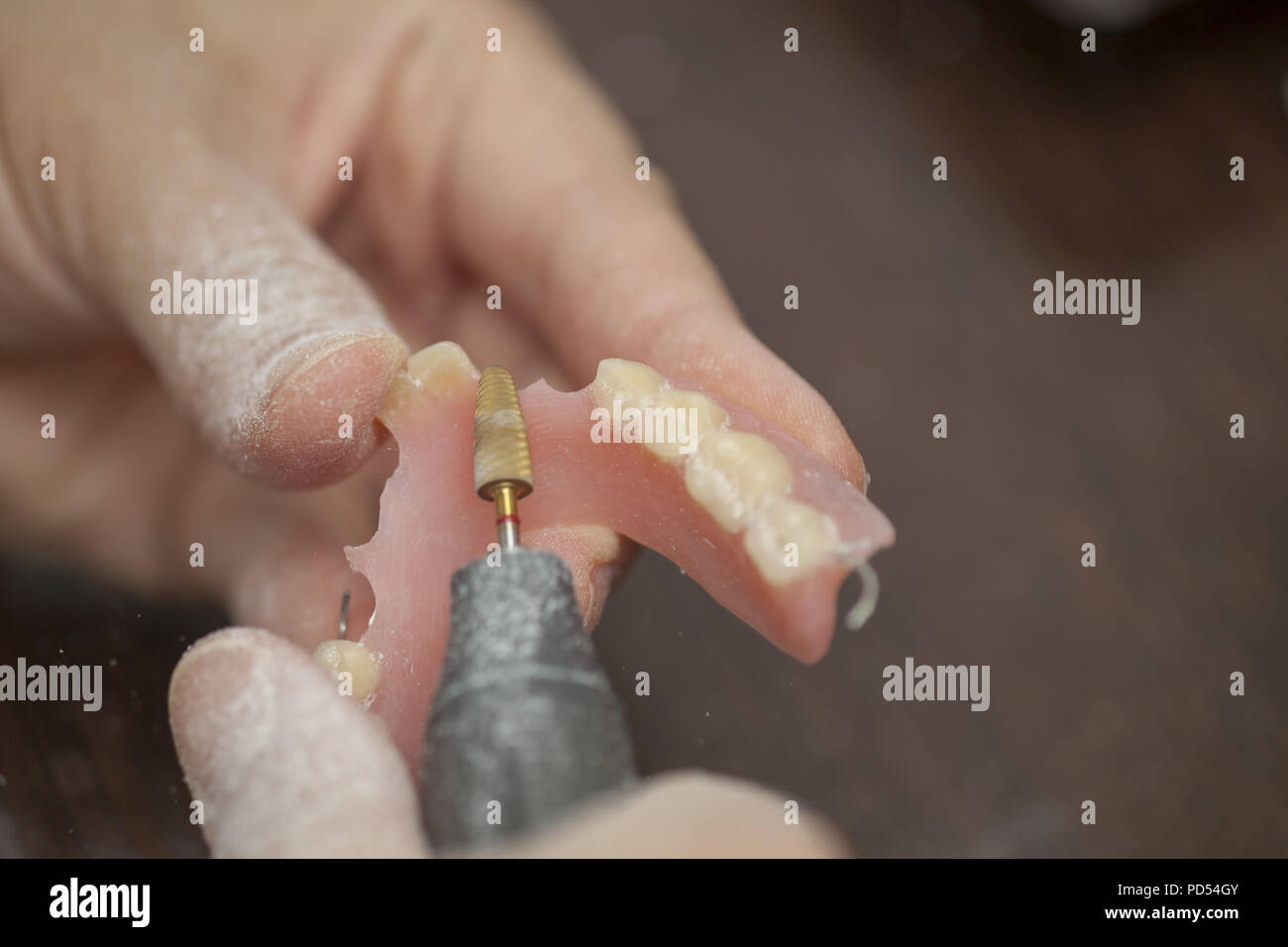 Dental technician make prothesis denture in dental laboratory, close up