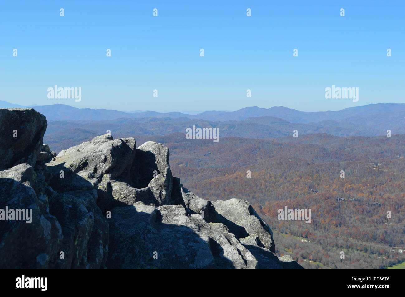 Rugged Boulders Overlook Dynamic Mountain Range. Stock Photo