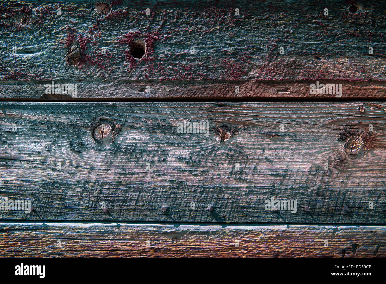 Weathered wood background texture with red, purple, green, and brown color tones Stock Photo