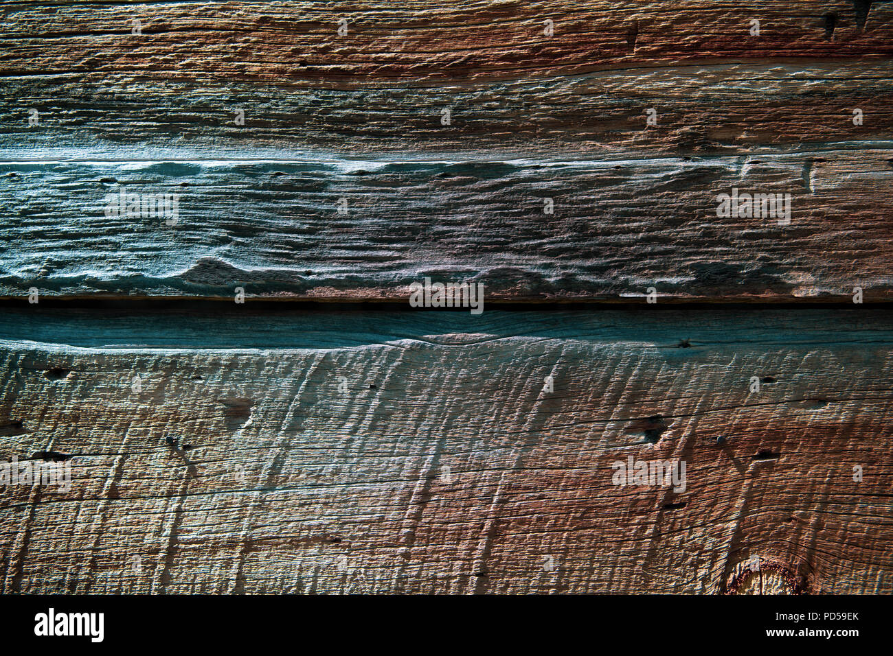 Weathered wood background texture with red, purple, green, and brown color tones Stock Photo