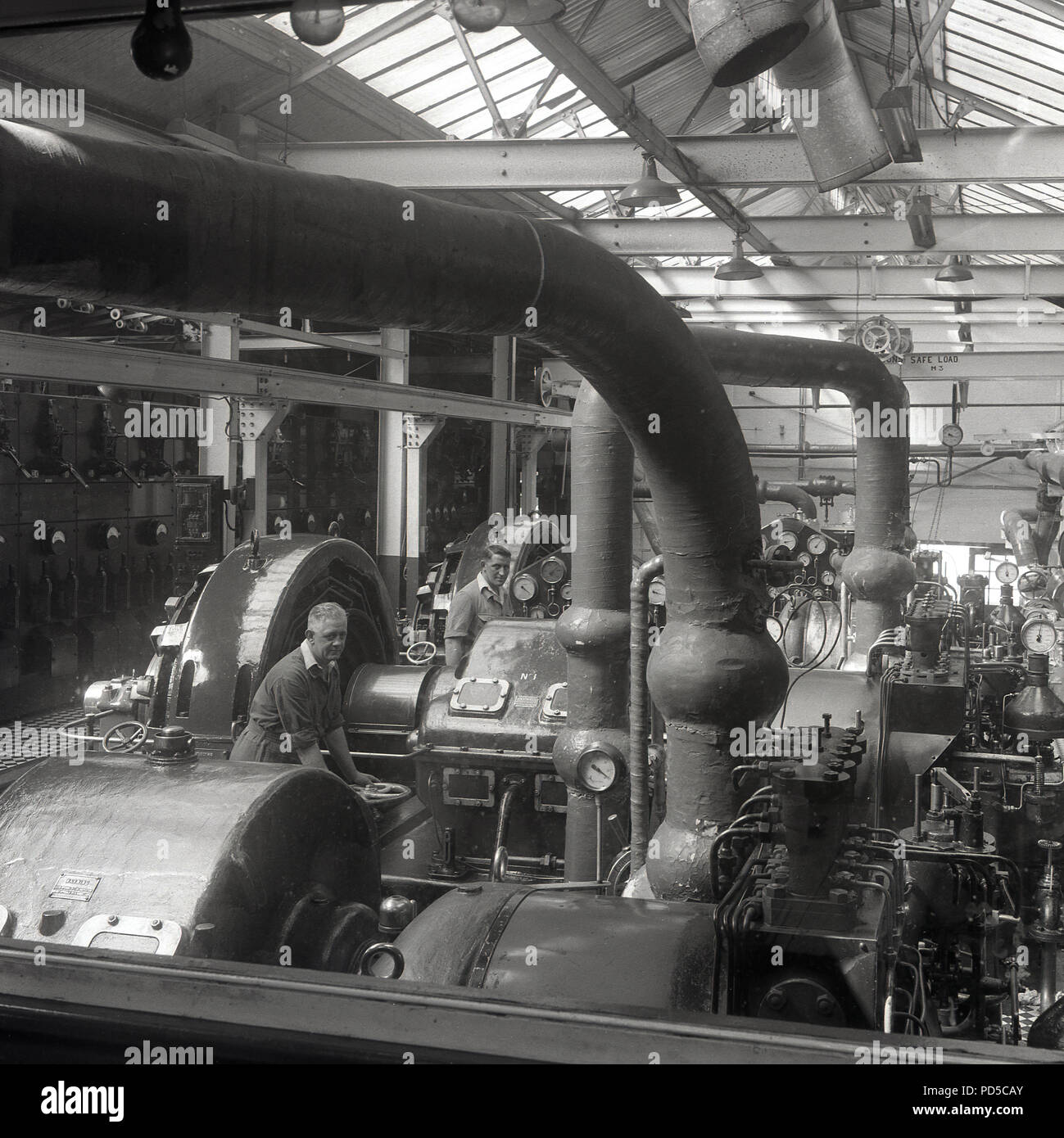 1950s, inside the Brittains paper mill at Cheddleton, England, a male