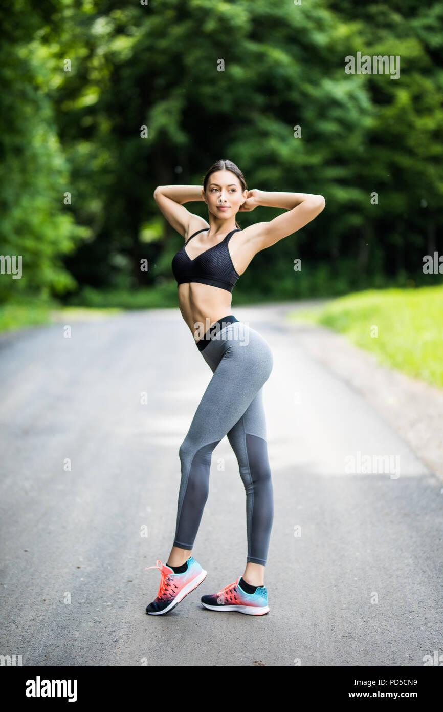 Young female workout before fitness training session . Healthy young woman  warming up outdoors. She is stretching her arms and looking away. 23748361  Stock Photo at Vecteezy
