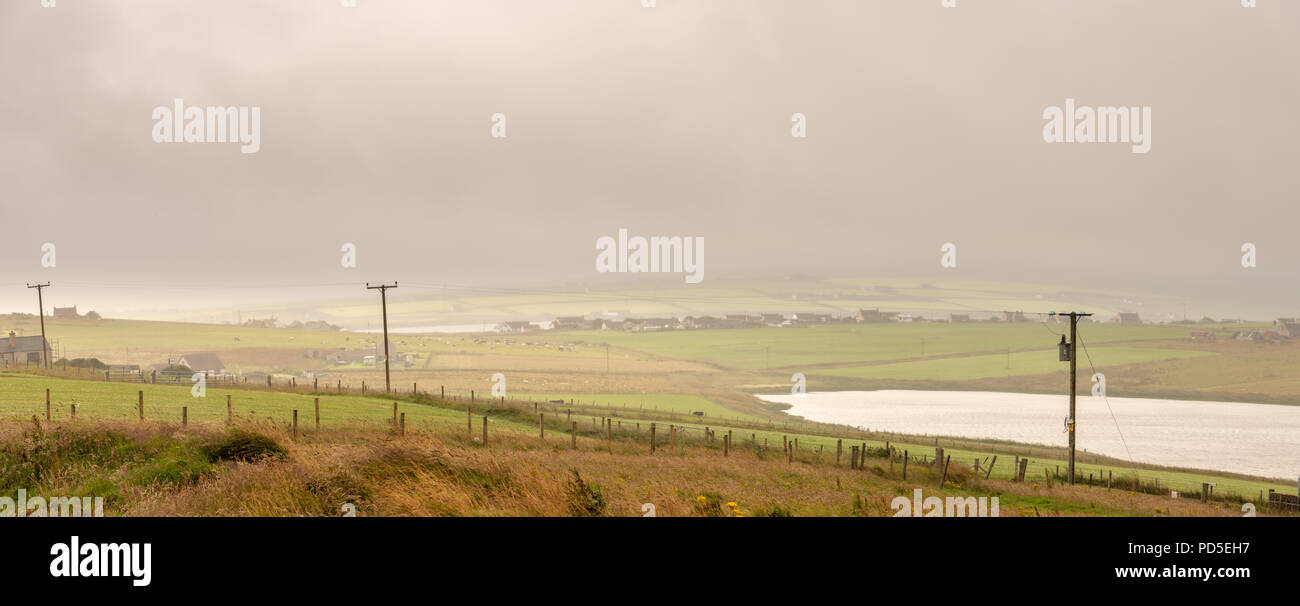 Looking across Burray towards the village on a misty morning Stock Photo