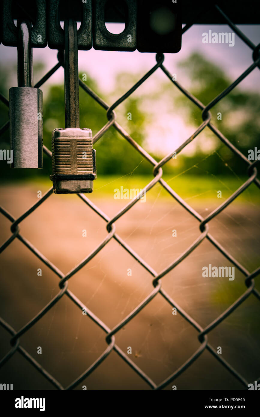 Two locks close up on wire fencs. Stock Photo
