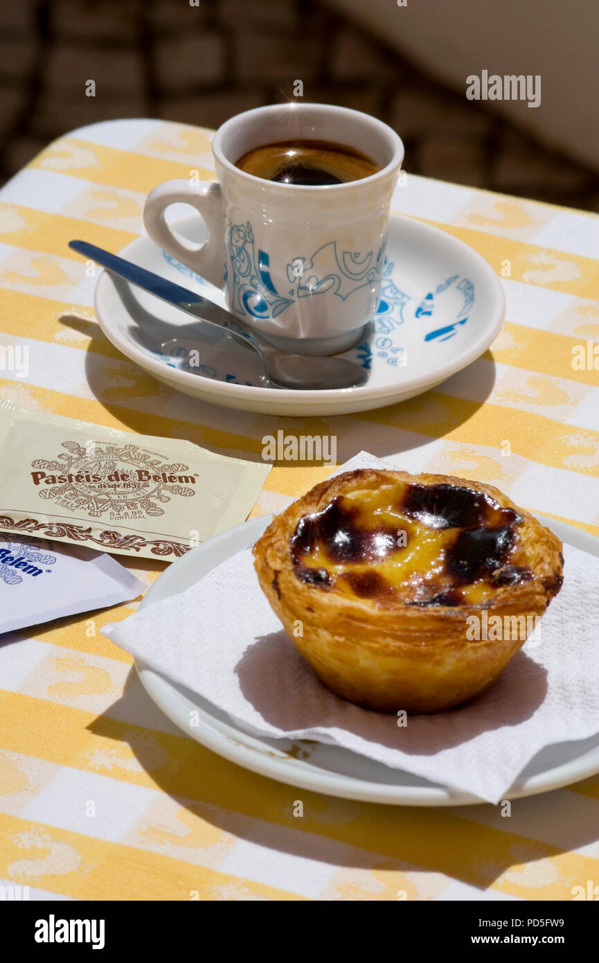 Pastel de nata cake and bica coffee on a café table, Portugal Stock Photo