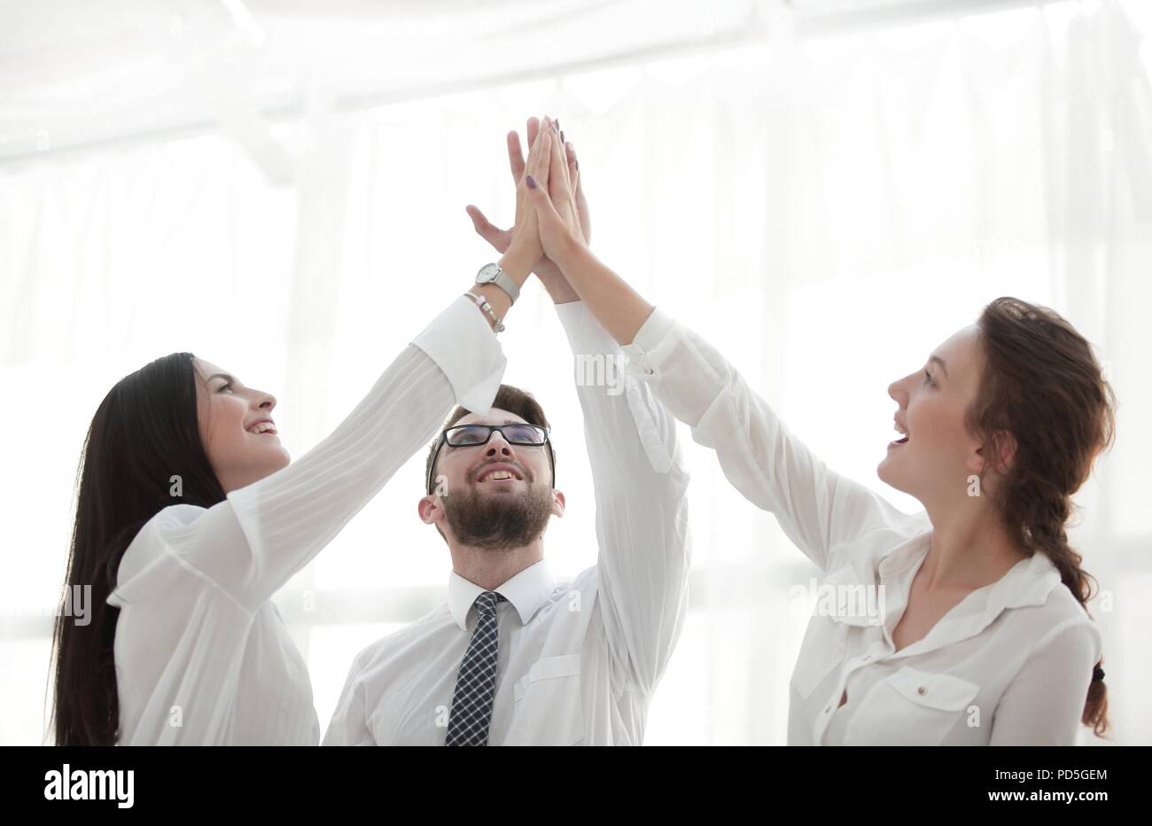 successful business team giving each other a high five Stock Photo - Alamy