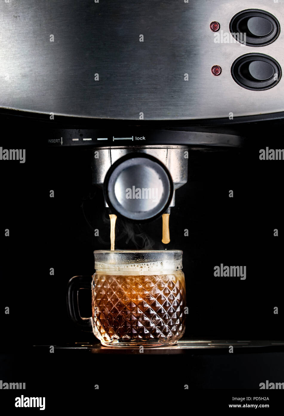 Dramatic shot of an espresso machine, closeup, brewing fresh coffee on