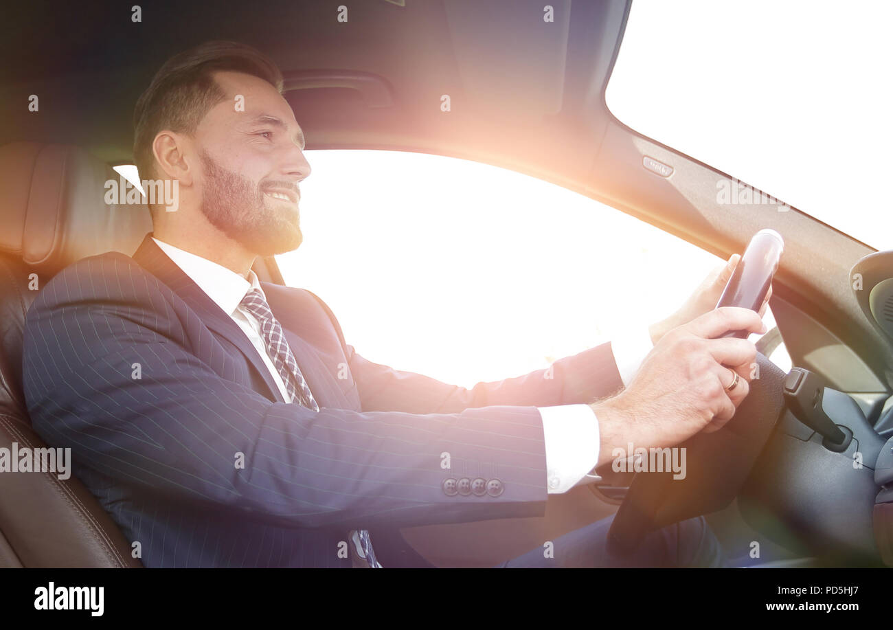 businessman sitting behind the wheel of a car Stock Photo - Alamy