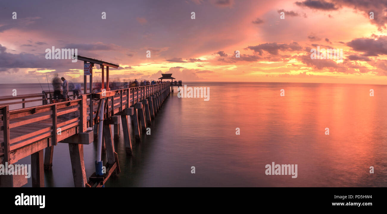 Pink and purple sunset over the Naples Pier on the Gulf Coast of Naples, Florida in summer. Stock Photo