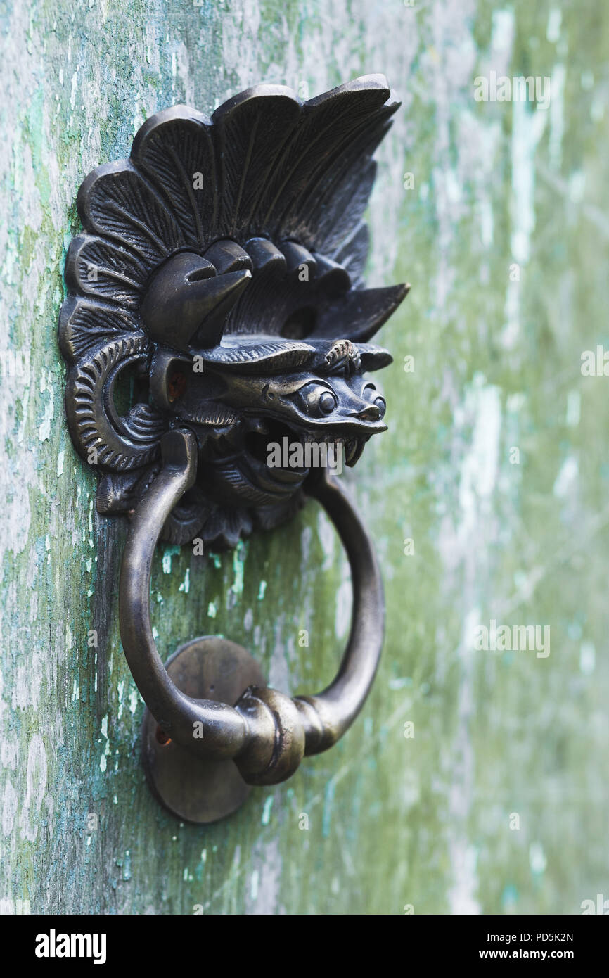 Old door knob in dragon shape Bali style Stock Photo