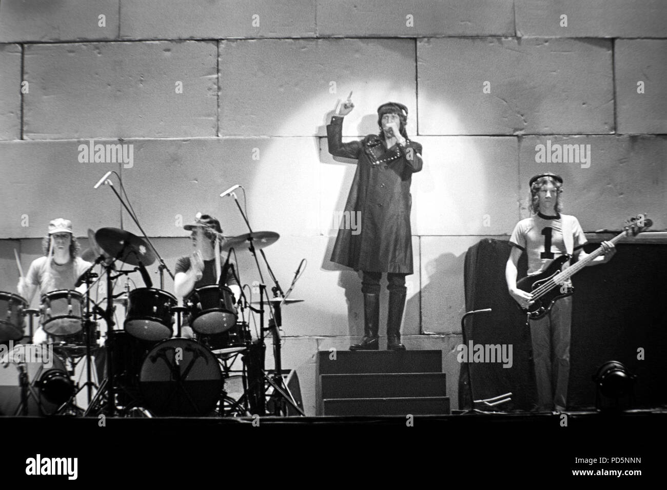 Dortmund, Germany, 20th. Feb.1981 - Roger Waters (in coat) of british psychedelic rock band PINK FLOYD performing THE WALL concert at the Westfalenhalle in Dortmund/Germany (digital image from a b/w-film-negative) Stock Photo