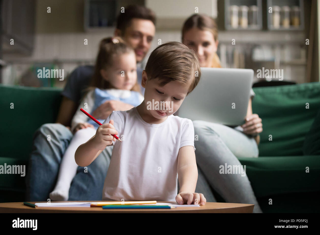 Kid boy drawing with colored pencils, creative child activities  Stock Photo