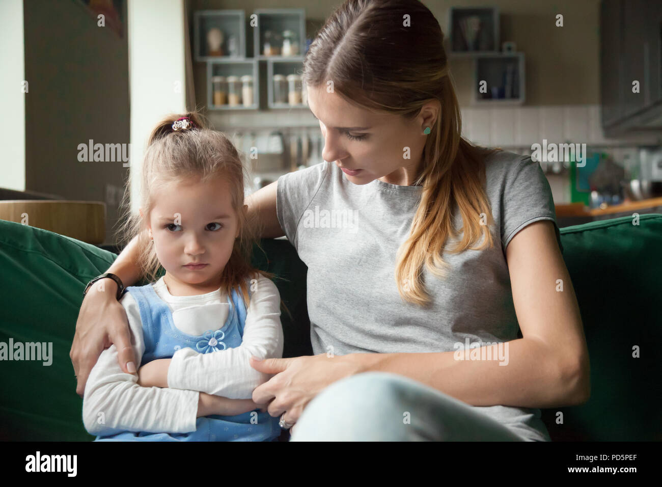 Loving mother consoling insulted upset stubborn kid daughter avo Stock Photo