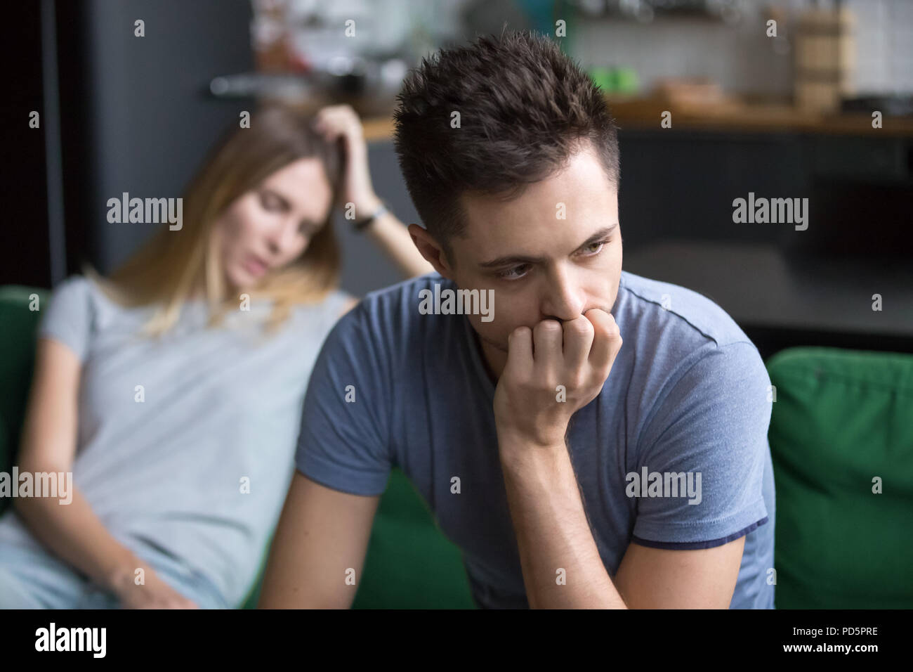 Upset boyfriend thinking of family conflicts after fight with gi Stock Photo