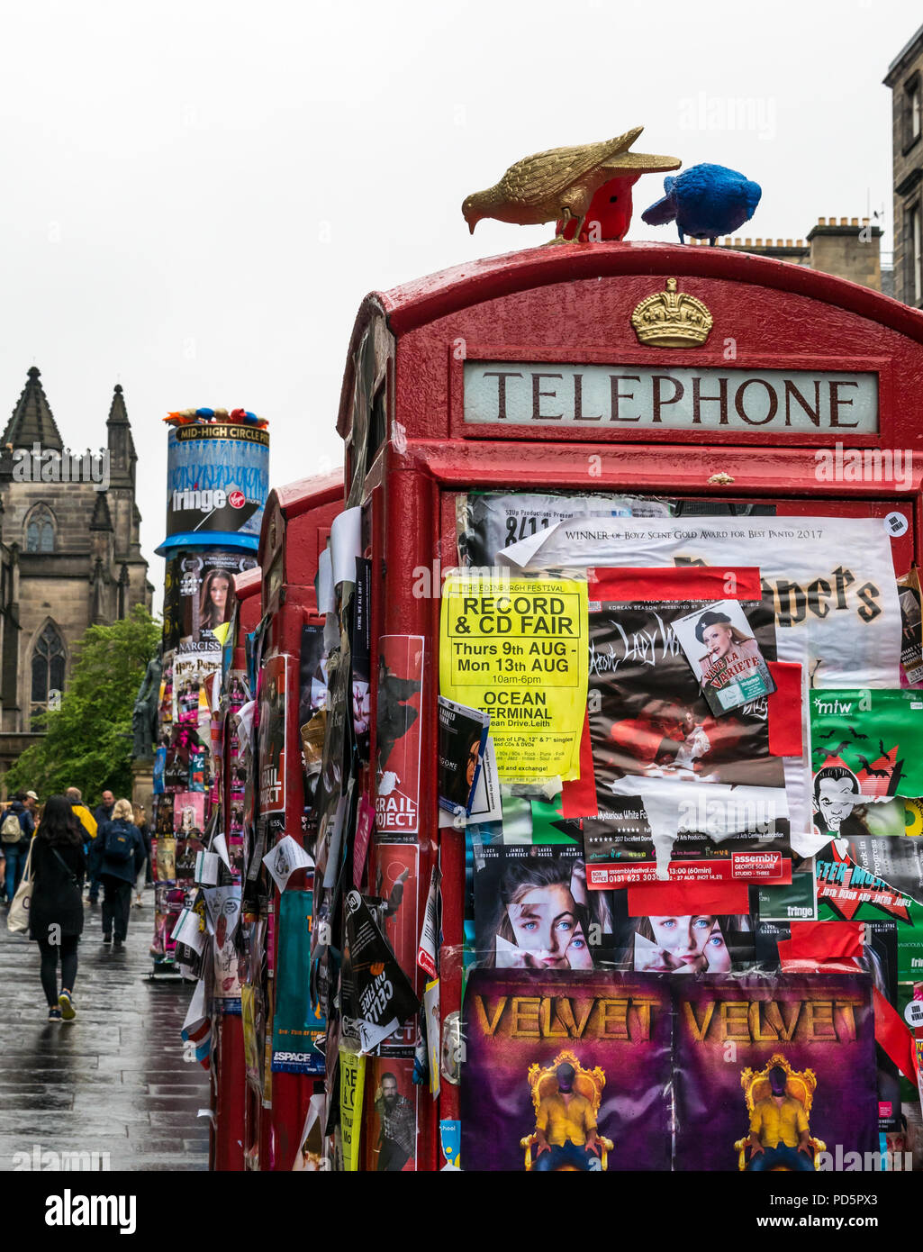 Virgin Money sponsored outdoor fringe venue, Royal Mile, Edinburgh, Scotland, UK with disused red telephone boxes covered in Fringe flyers Stock Photo