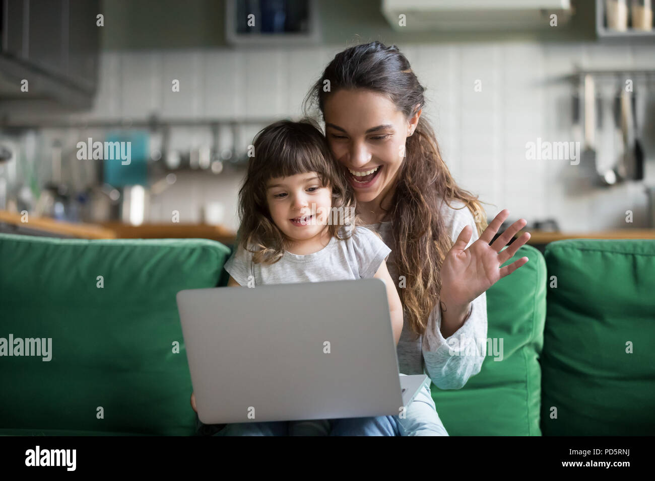 Happy mother and kid girl waving hands making video call Stock Photo ...