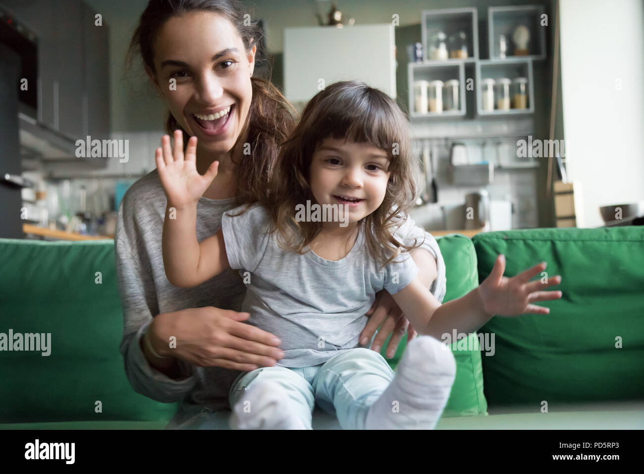 Happy mother and kid looking at camera recording videoblog, port Stock Photo