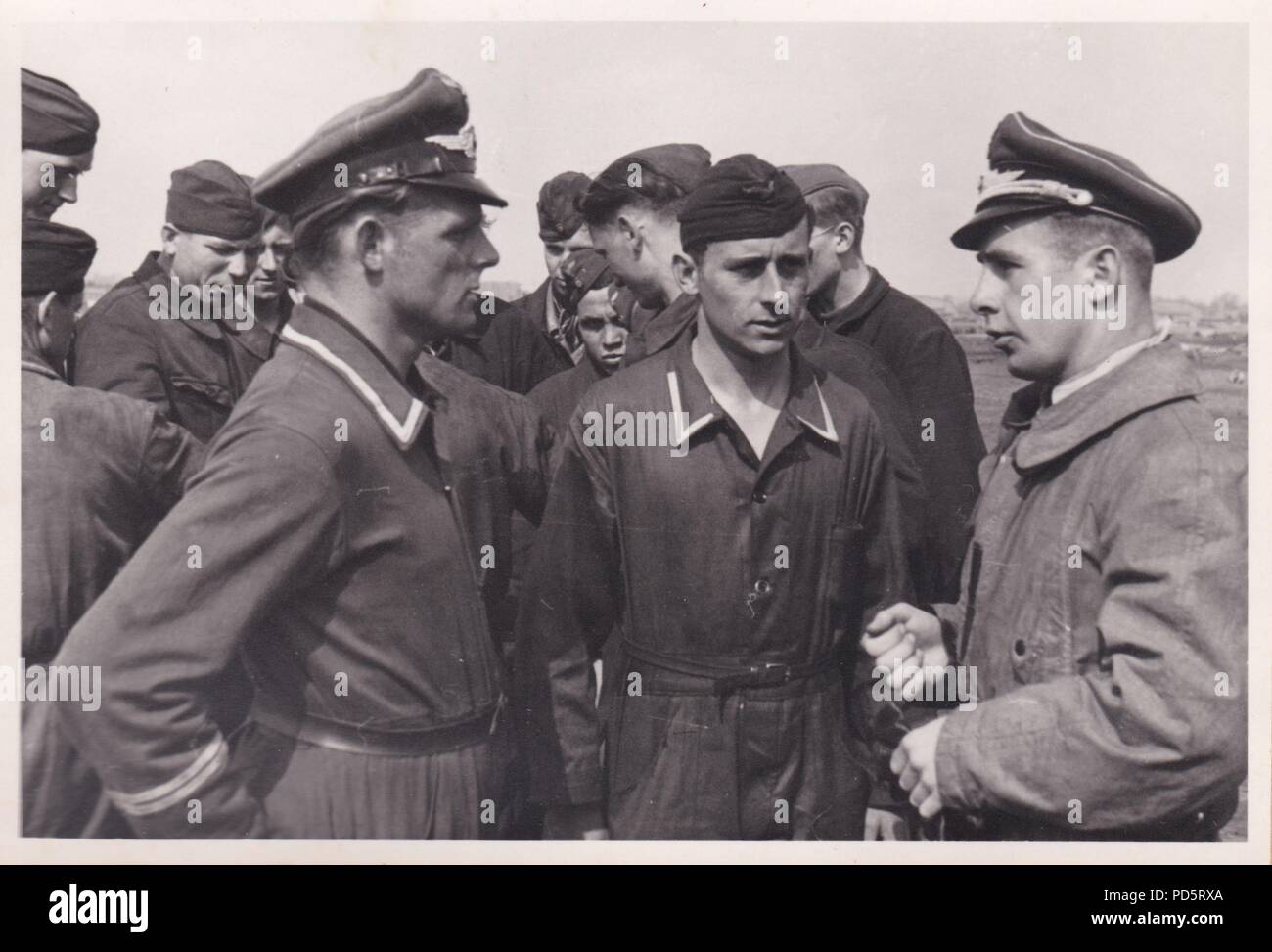 Image from the photo album of Oberleutnant Oscar Müller of  Kampfgeschwader 1: A Luftwaffe officer talks to members of the ground crew of 5. Staffel Kampfgescwader 1 'Hindenburg' at Dno Airfield in Russia, 1942. Stock Photo
