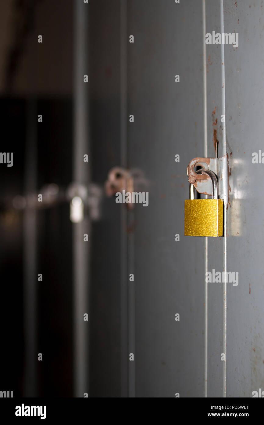 Grey neutral lockers with padlocks for gym, dressing room, company, school for personal storage Stock Photo
