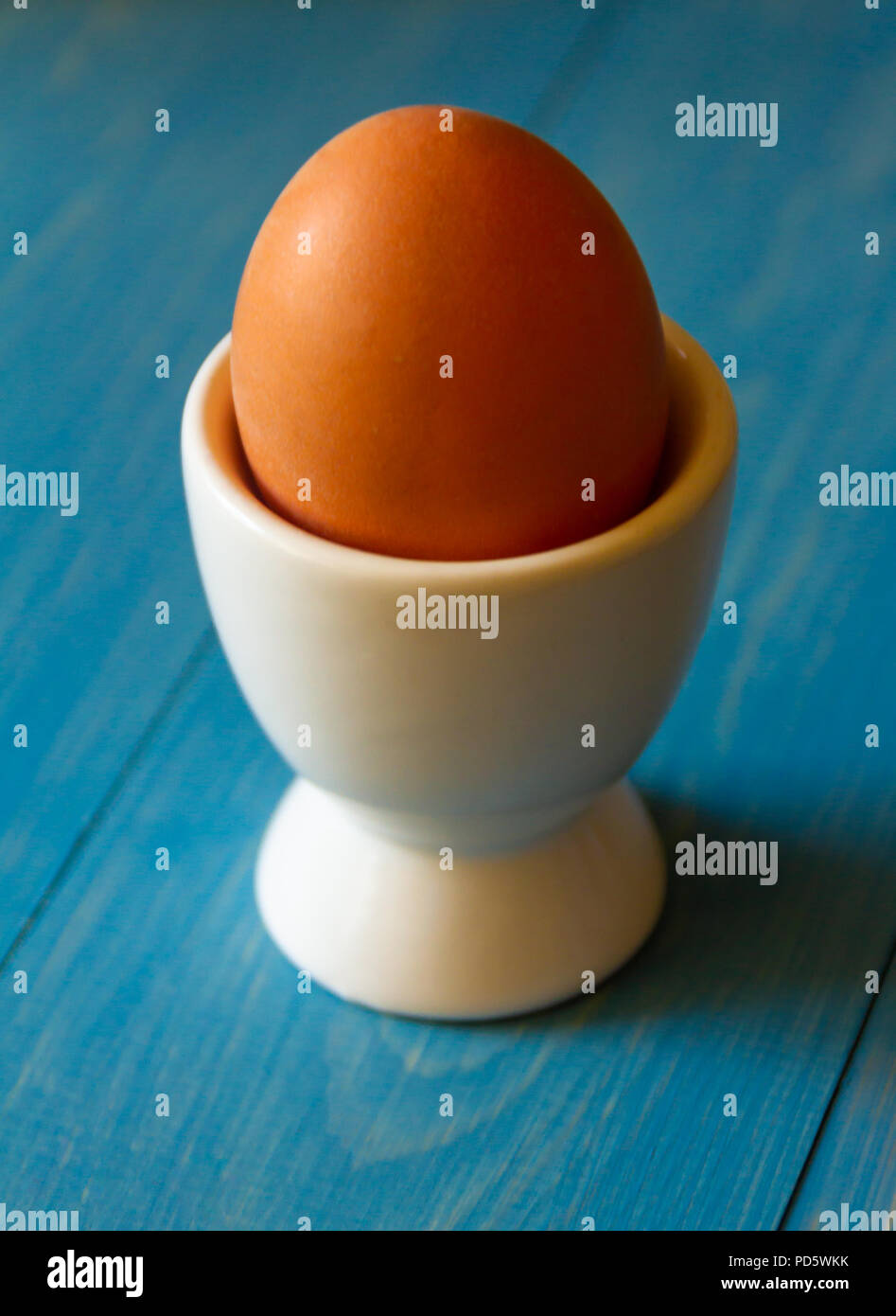 Boiled egg in a white egg cup Stock Photo